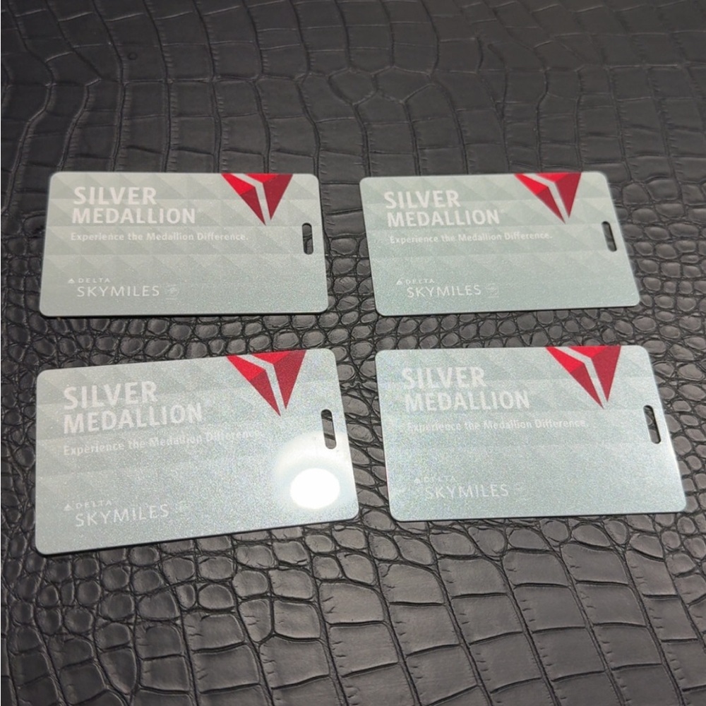 4 Brand New Delta Silver Medallion Tags with Red Accents
